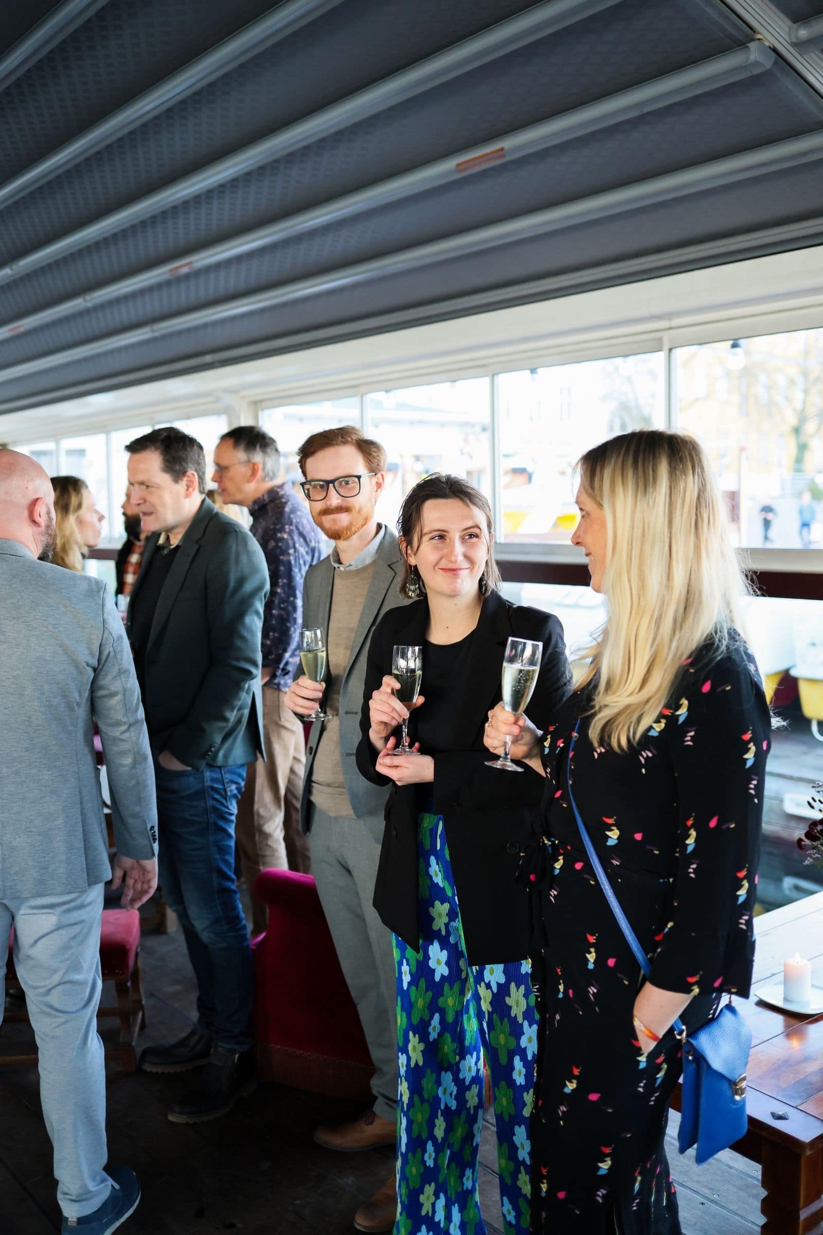 People mingling with drinks at an event. Photo by Pexels via Pexels.