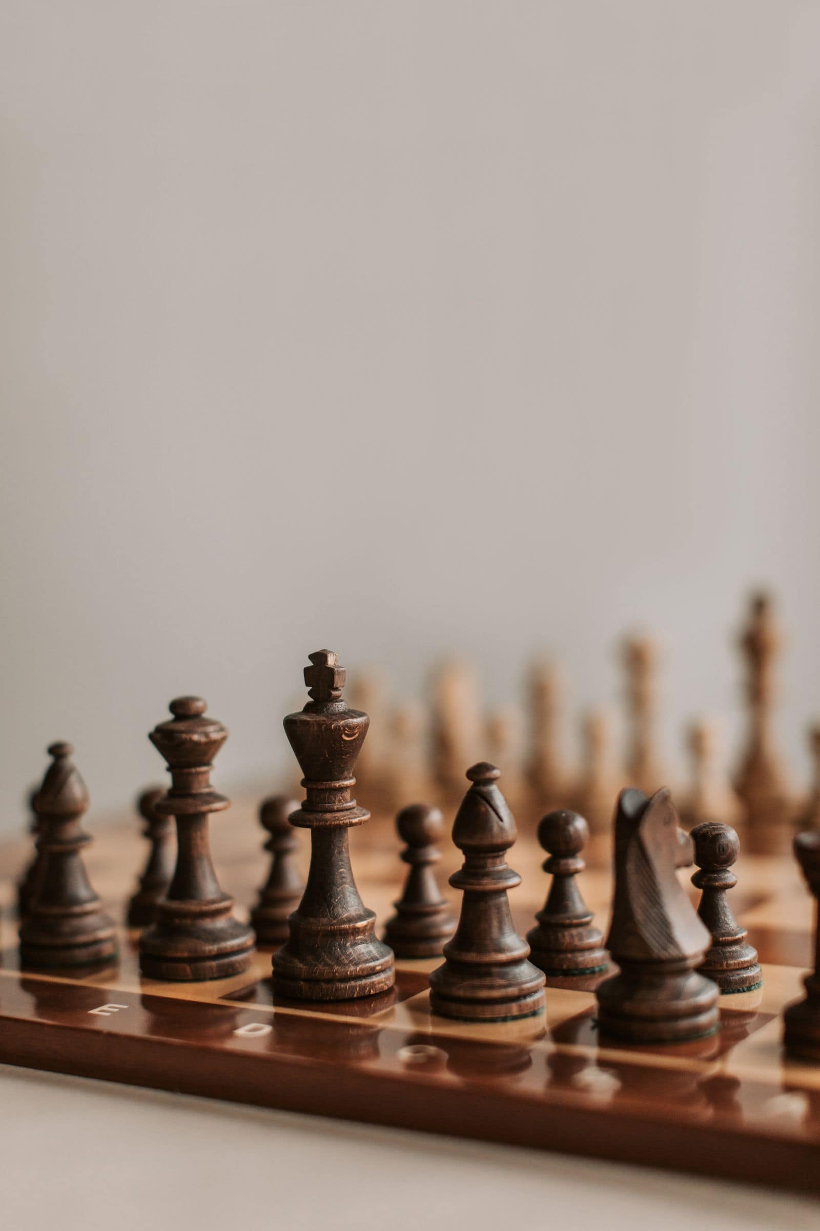 Chess pieces mid game on a wooden board. Photo by Vlada Karpovich via Pexels.