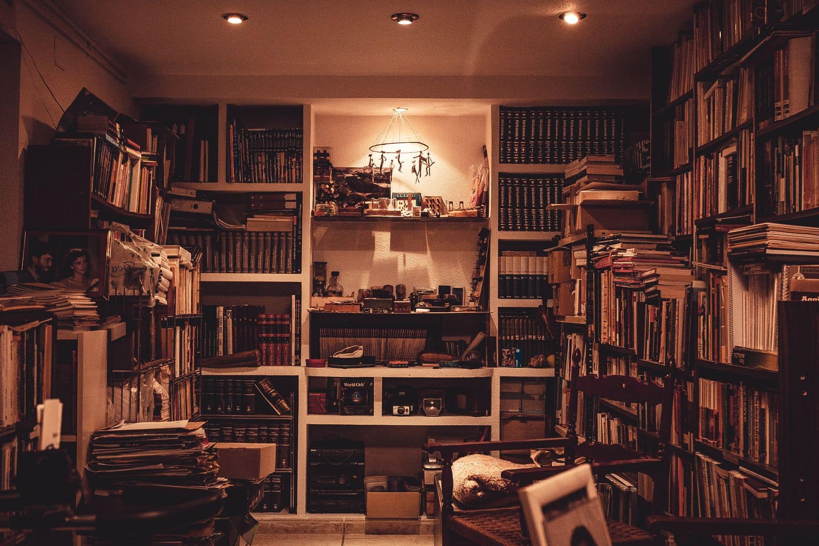 A small room crammed floor to ceiling with second hand books. Photo via Pexels (photo 877971).